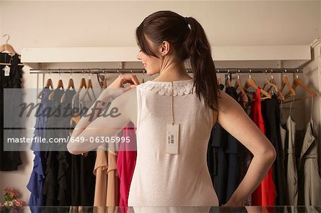 Woman trying on shirt in store