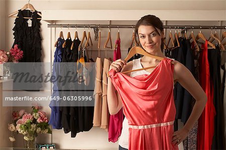 Woman examining dress in store
