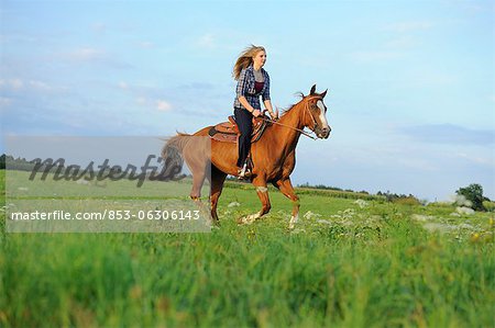 Teenage girl riding on horse