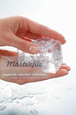 Hands holding a piece of ice