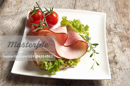 Open face sandwich with turkey ham and Lollo Bianco, thyme and cherry tomatoes