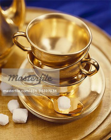 Gold Tea Cups, Saucers and Spoon; With Sugar Cubes