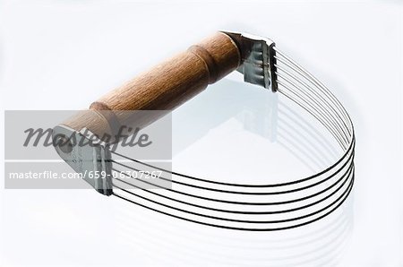 Metal Pastry Cutter with Wooden Handle on a White Background