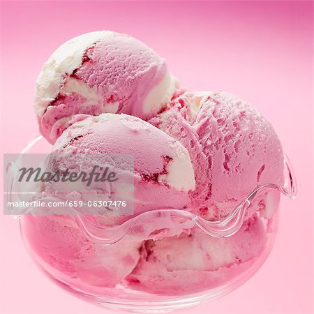 Raspberry and vanilla ice cream in a glass bowl