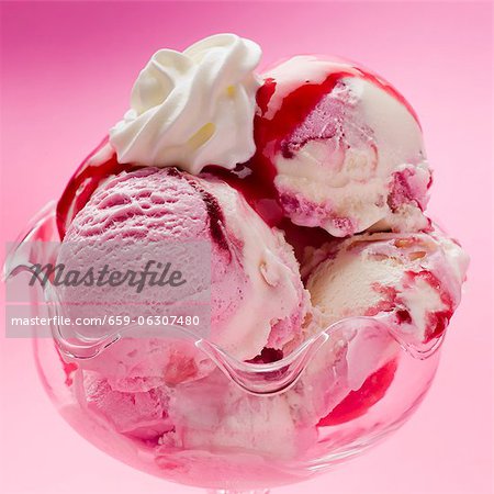 Raspberry and vanilla ice cream with raspberry sauce and cream (close-up) Raspberry and vanilla ice cream with raspberry sauce and cream (close-up)
