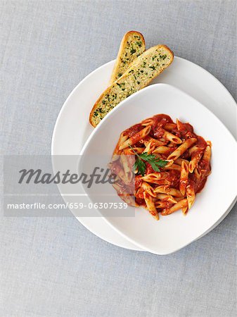 Penne with tomato sauce and garlic bread (seen from above)