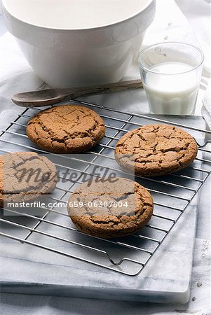 Fresh Homemade Molasses Cookies on a Cooling Rack; Glass of Milk