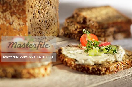 Slices of wholemeal bread topped with herb quark and vegetables