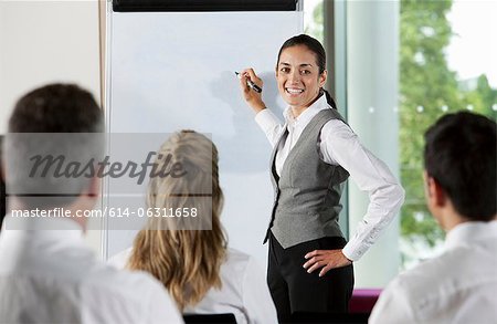 Woman using whiteboard in business meeting