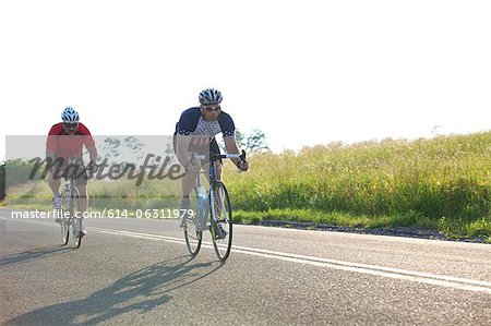 Two cyclists riding on road