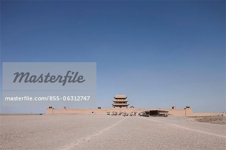 Tourists riding on camel at Fort of Jiayuguan Great Wall, Jiayuguan, Silkroad, China