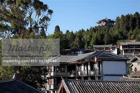 Ancient residential rooftops and Wan Gu Lou in the distance, Old town of Lijiang, Yunnan Province, China