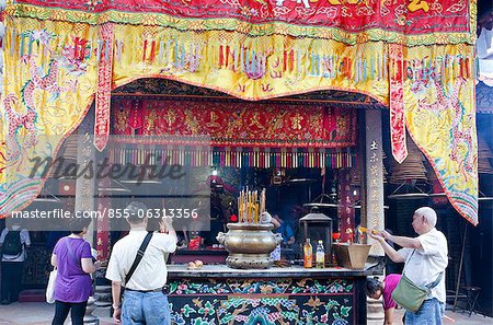Worshippers offering incense at Pak Tai Temple during the Bun festival, Cheung Chau, Hong Kong