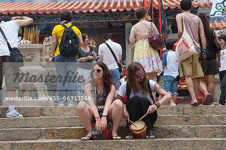 Foreign visitors sharing the atmosphere of the Bun festival at Pak Tai Temple, Cheung Chau, Hong Kong