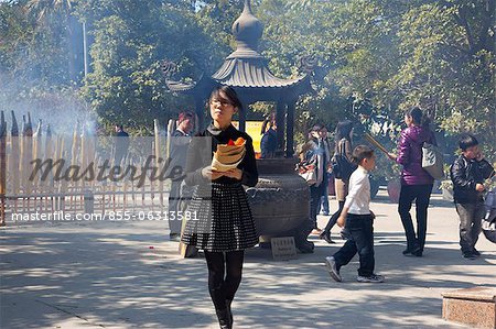 Worshipper offering at Po Lin Monastery, Lantau Island, Hong Kong