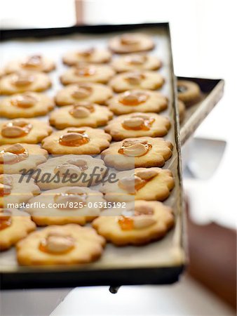 Almond cookies with apricot jam on a baking tray,Toscany