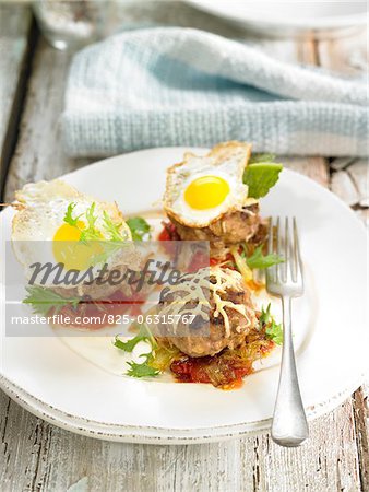 Mini horse meat burgers topped with fried quail's eggs ,cheese and vegetables