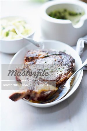 Grilled beef chop and mashed potatoes with herb butter
