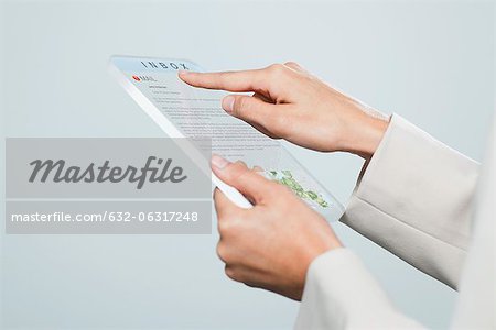 Woman checking email using futuristic digital tablet, cropped