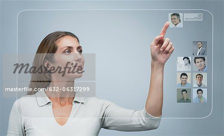 Woman using internet dating service on advanced touch screen interface