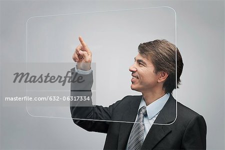 Businessman using large transparent touch screen