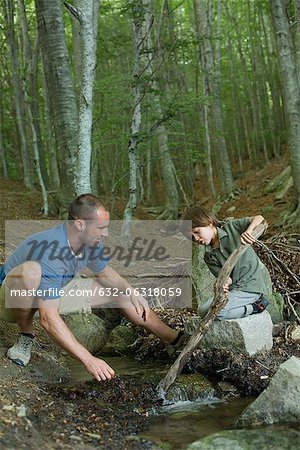 Father and son playing in woods
