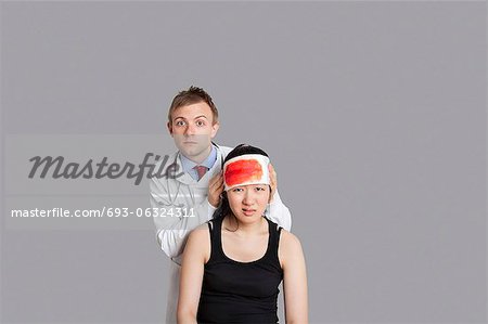 Portrait of a doctor treating his female patient