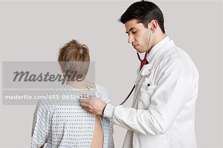 Indian doctor examining male patient