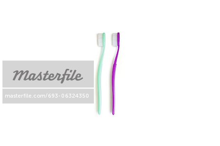 Two toothbrushes over white background