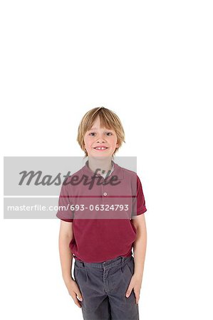 Portrait of happy elementary boy in school uniform over white background