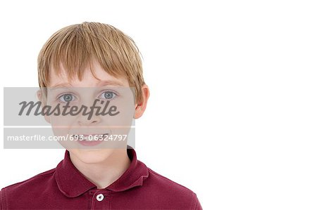 Close-up portrait of a happy pre-teen boy over white background