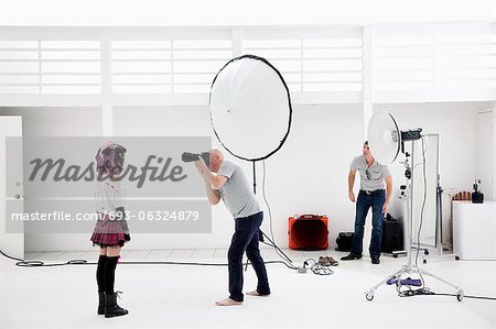 Photographer shooting fashion model in photo shoot