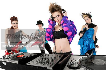 Portrait of all female punk rock band over white background