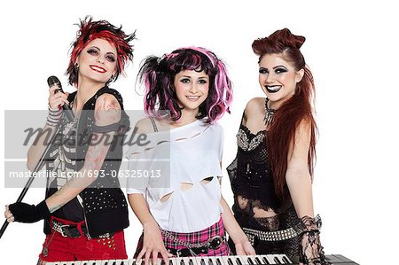 Beautiful young punk woman with piano and microphone over white background Beautiful young punk woman with piano and microphone over white background