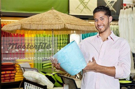 Happy young man holding a souvenir in store