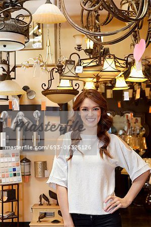 Portrait of beautiful young woman standing in lights store