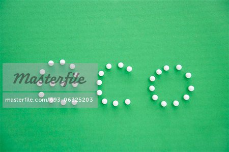 Close-up of push pins spelling eco over green background
