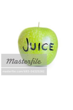 Close-up of text on a granny smith apple over white background