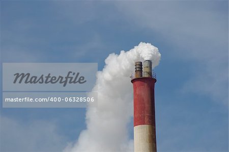 smoky chimney on background of blue sky