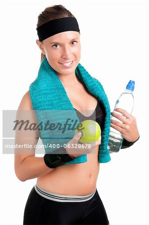 Woman holding an apple and a bottle of water after a workout in the gym, isolated in a white background