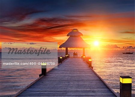 Vivid sunset over the jetty in the Indian ocean, Maldives. HDR