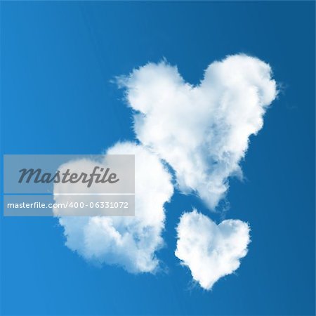 three heart-shaped clouds on blue sky background.  Concept of family
