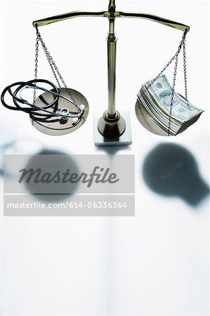 Weighing scales with stethoscope and banknotes