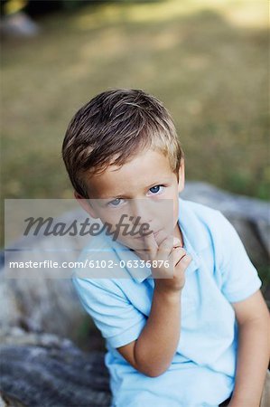 Portrait of boy with finger on lips