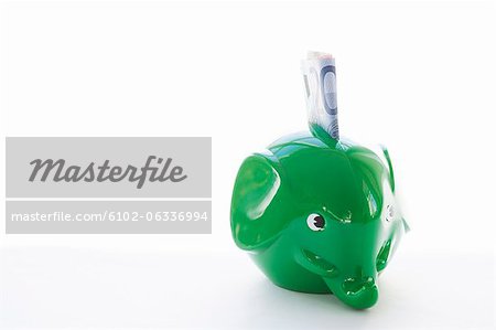 Elephant-shaped piggy bank with money