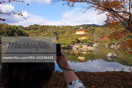 A tourist taking photo of Rokuon-ji Temple (Kinkakuji), Kyoto, Japan