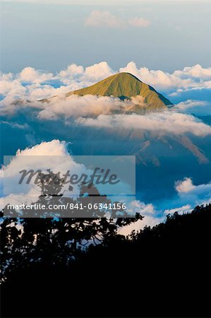 Mountain summit rising high above the clouds taken from Mount Rinjani volcano, Lombok, Indonesia, Southeast Asia, Asia