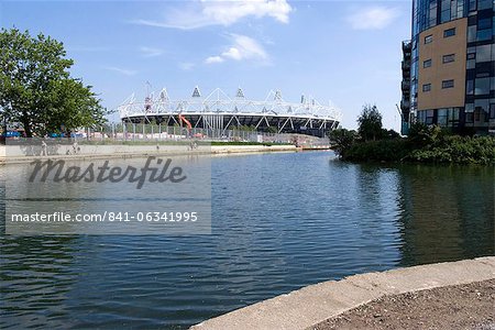 View of the Olympic Stadium from the Lee Valley River navigation, the canalised waterway next to the London OIympic site, Stratford, London, England, United Kingdom, Europe