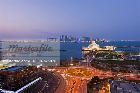 Elevated view over the Museum of Islamic Art and the Dhow harbour to the modern skyscraper skyline, Doha, Qatar, Middle East