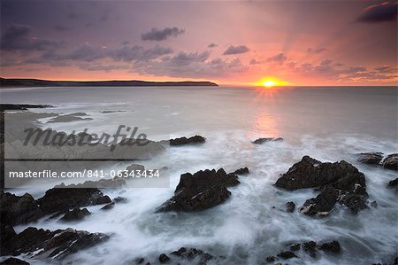 Sun setting over the Atlantic, viewed from Woolacombe Bay in Devon, England, United Kingdom, Europe